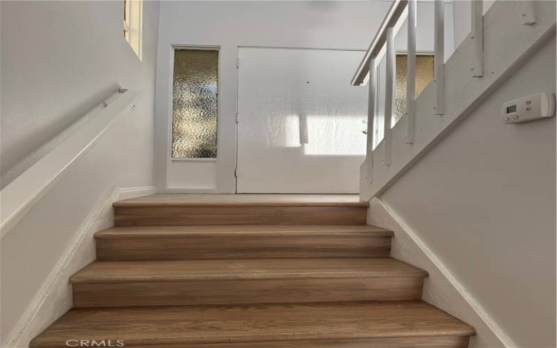 Stairs going from lower bedrooms to upper living area