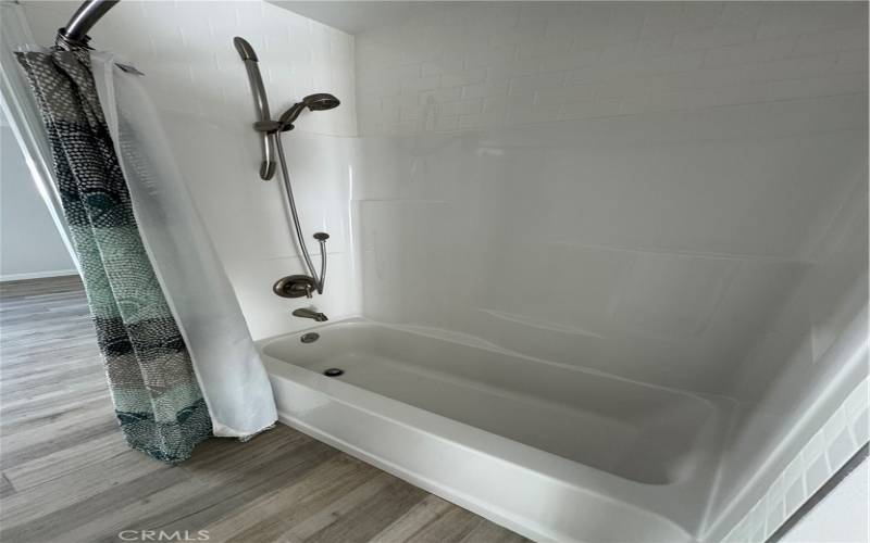 Tub and shower in lower bedroom area