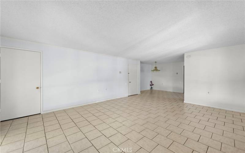 Another view of the open concept of the Dinging room and living room, 

 & of the front entrance door at the right and the other door is a convenient t closet door.