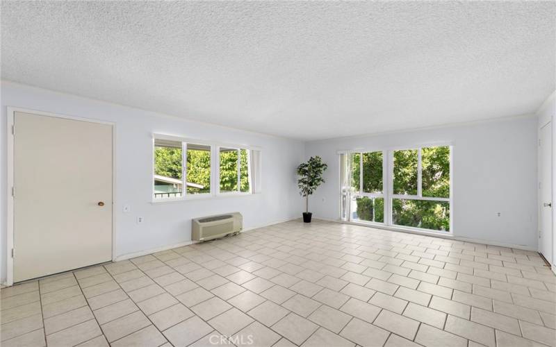 Lots of windows in the living room for your enjoyment of different views of the trees and neighborhood.

The door leads you out to the Balcony for your your convince and enjoyment. Opposite side Rm. extra closet space