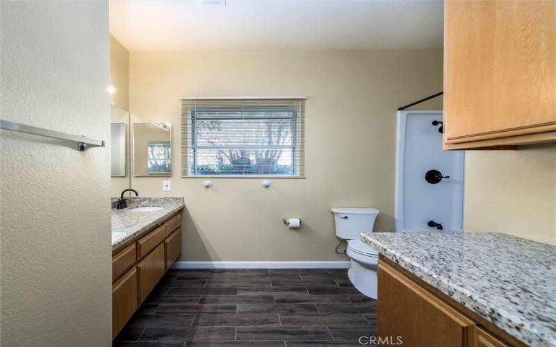 OVERSIZED hall bathroom with NEWER shower enclosure, plenty of storage and space with granite counters