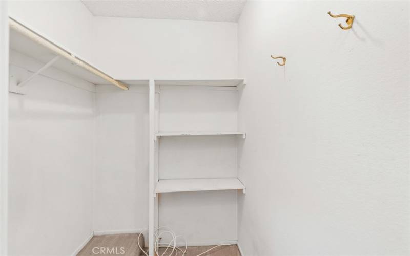 Primary bedroom walk-in closet