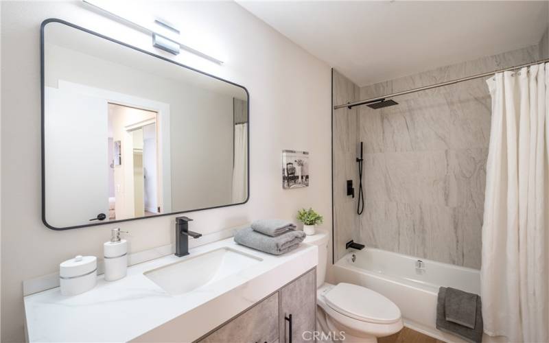 Second primary-suite fully upgraded bathroom with floor-ceiling tile shower/tub combo and floating vanity