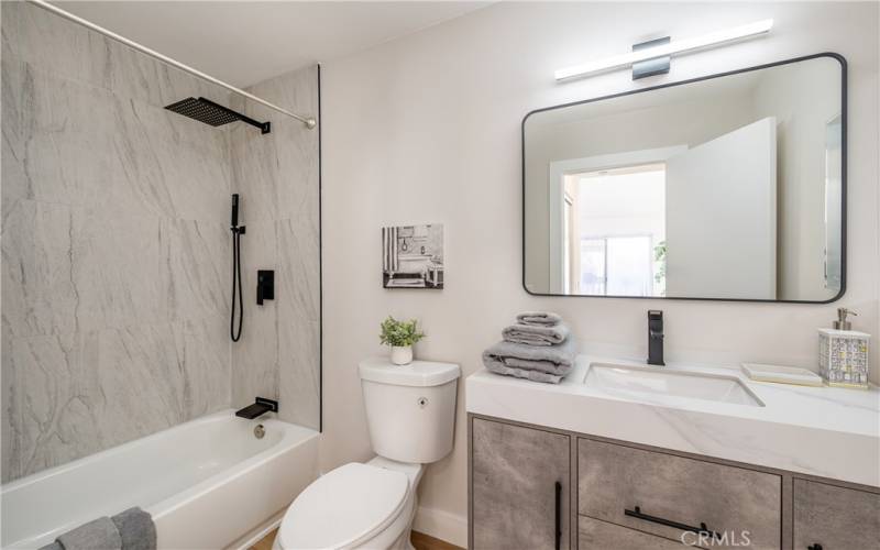 Primary suite fully upgraded bathroom with floor-ceiling tile shower/tub combo and floating vanity