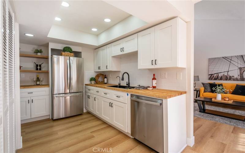 White shaker cabinets with butcher's block