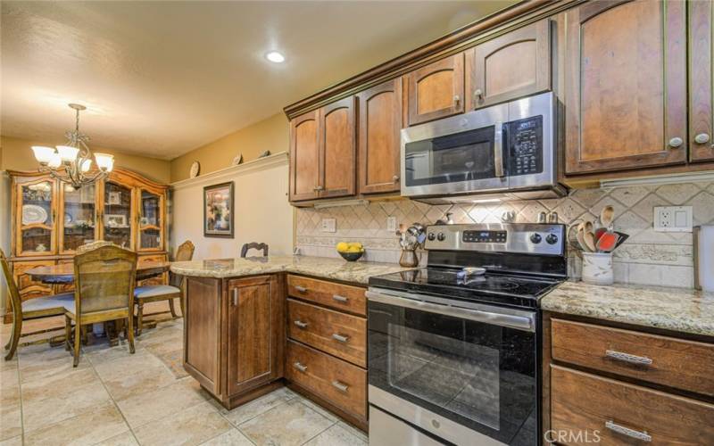 DINING AREA, S/S RANGE, MICROWAVE & TILE FLOORING