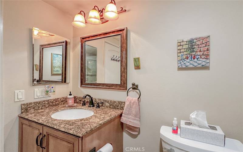 GUEST BATHROOM ACROSS HALL FROM GUEST BEDROOM, GRANITE COUNTERTOP & WOODEN CABINET