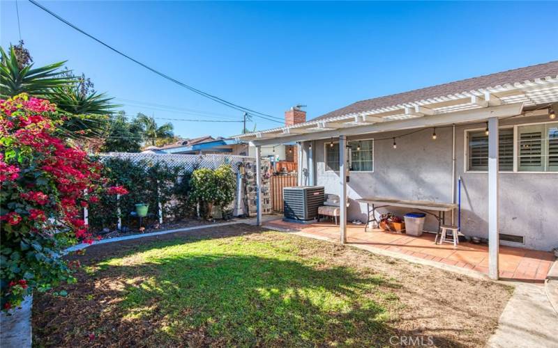 Private backyard, complete with plants, flower beds and plenty of space for BBQs or relaxation.