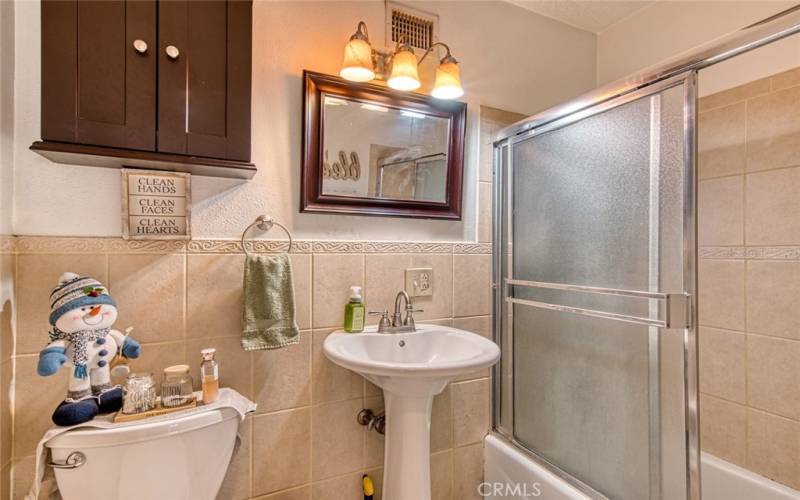 Hall bathroom with tub and shower combo.