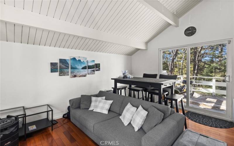 Downstairs living room and eating area with balcony