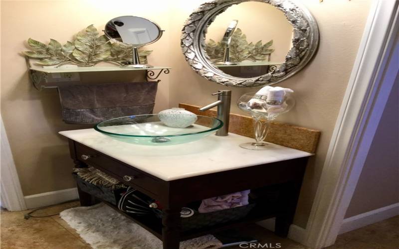 Vanity with marble top, glass bowl in master bath