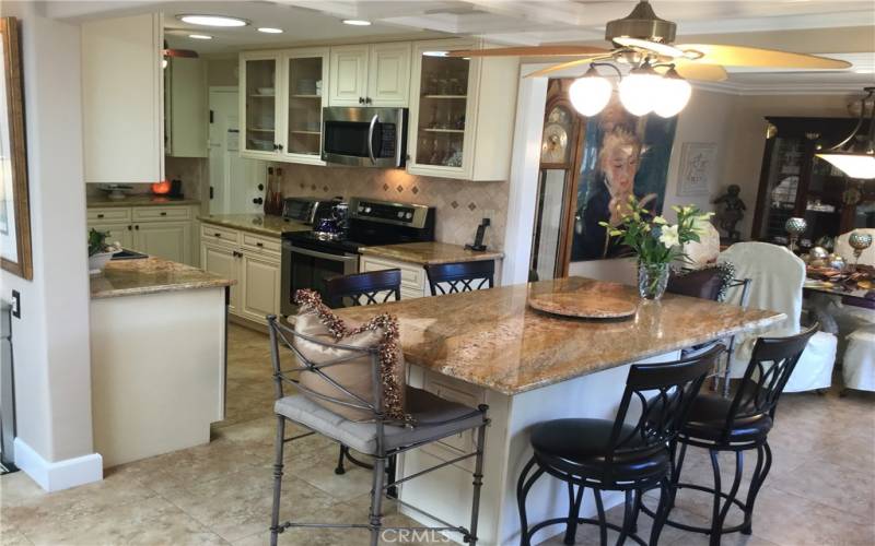 Island with granite countertop, custom cabinets, custom designed heavy mouldings on dining area ceilings. The island is approximately 4ft.x 6ft. and could hold 10 persons.