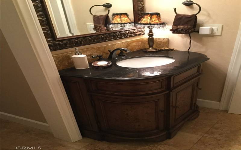 Granite top vanity in guest bath.