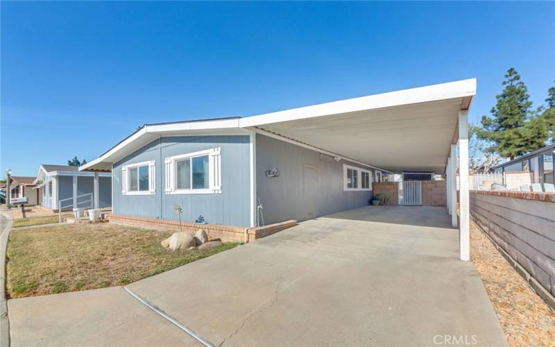 Two Car Tandem Carport with Porch Area and Shed