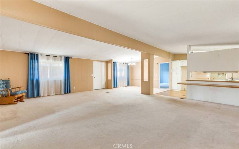 Large Open Living Area Showing the Kitchen and Dining Area and Primary Bedroom Entry