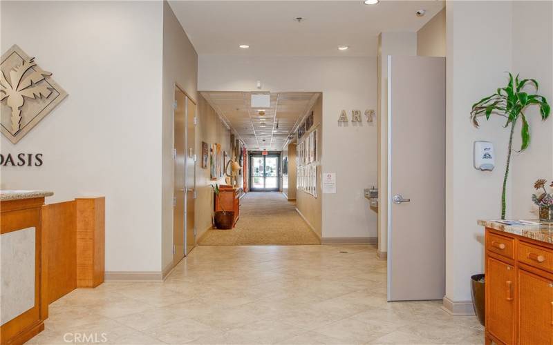 Hall to the media/card room, fitness center, library, multi-purpose rooms, computer center and billiard parlor.