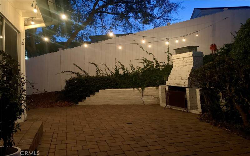 Patio with new fence and pavers.,