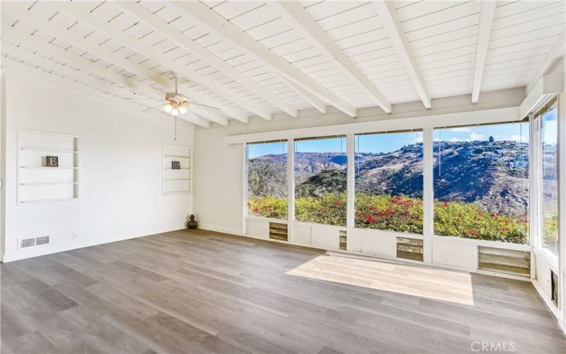 High ceilings, fresh paint and ceiling fan in living room.