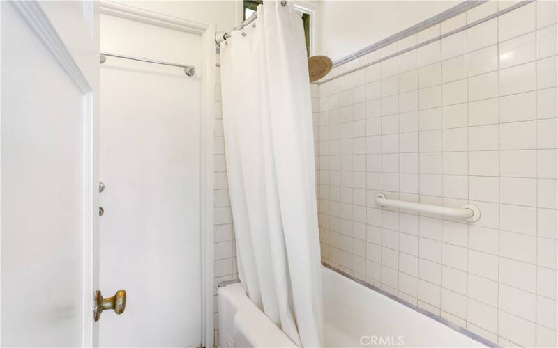 Shower over tub. This room is separate from the bathroom.