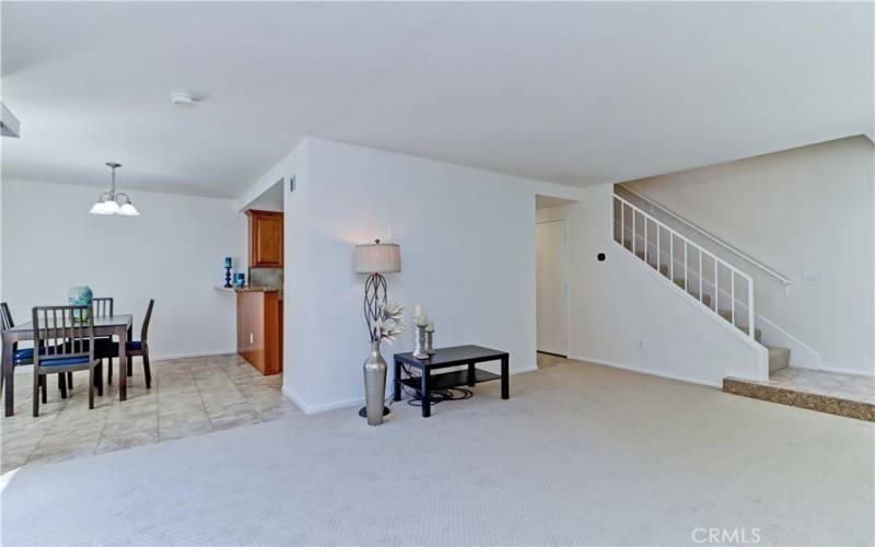 Living Room opens to dining area and kitchen. Laundry room doors to right.