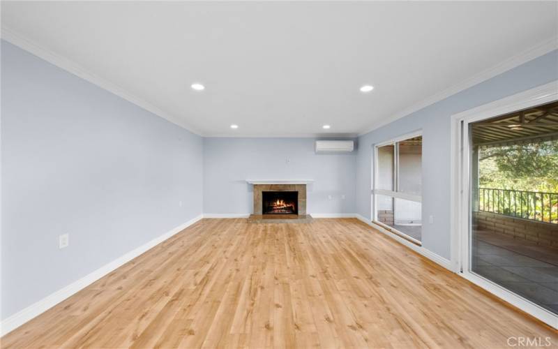 View of living room with sliding glass door and picture window