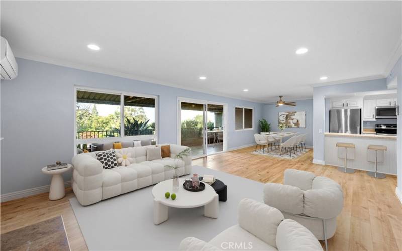 Living room virtually staged with dining area and kitchen in background