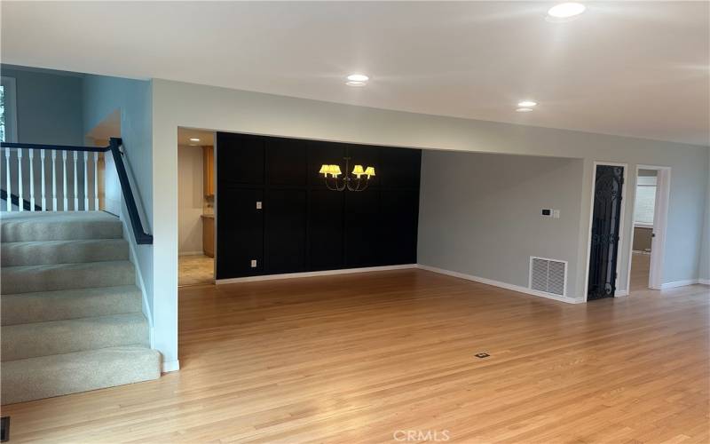 Formal dining room with stairs to family room