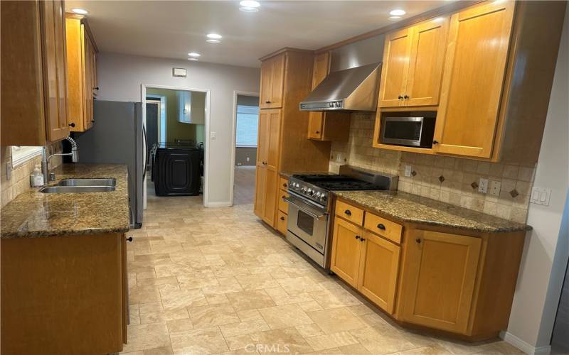 Galley kitchen adjacent to dining and family room and living room