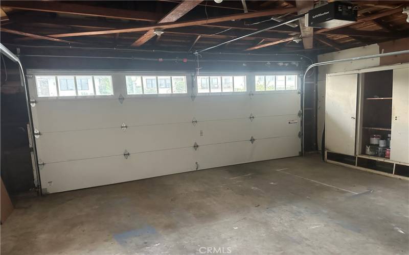 2 car garage with opener and roll up door