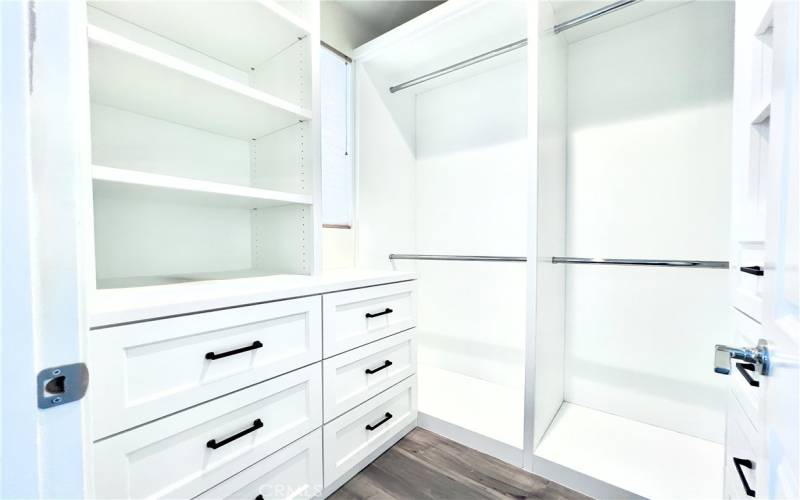 Primary bedroom walk-in closet