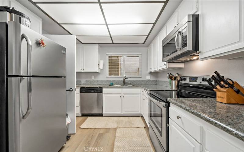 Well lit kitchen with window overlooking courtyard