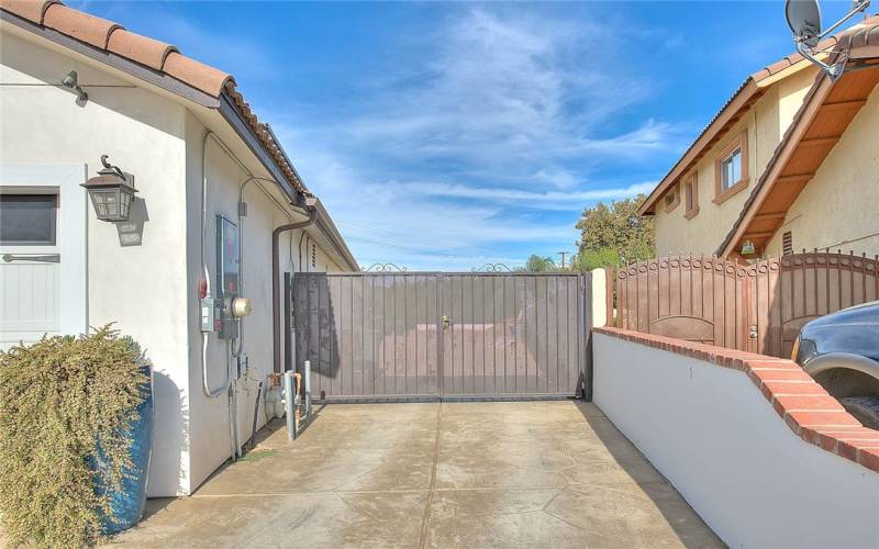 Gate to side yard with additional parking space