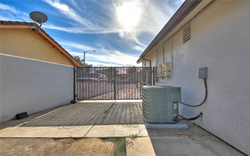 Side Yard with view of gate and HVAC condenser unit