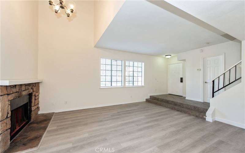 High ceiling living space with a fireplace