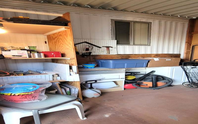 STORAGE AREA WITH SHELVES AND CABINETS