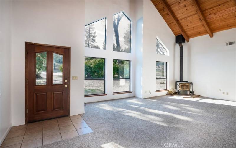 The vaulted wood ceiling and large windows are impressive features in the spacious great room.