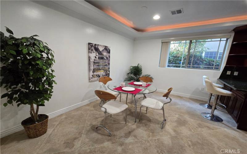 Dining room opens to a breakfast bar and kitchen