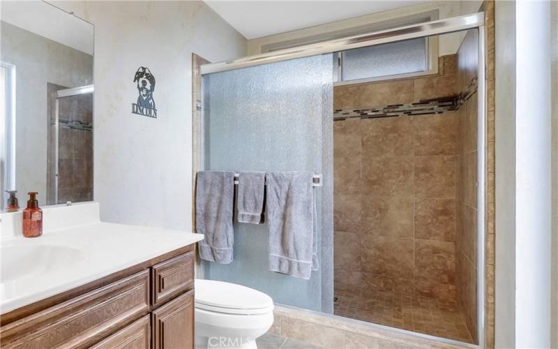 Large walk-in shower with beautiful tile in master bath.