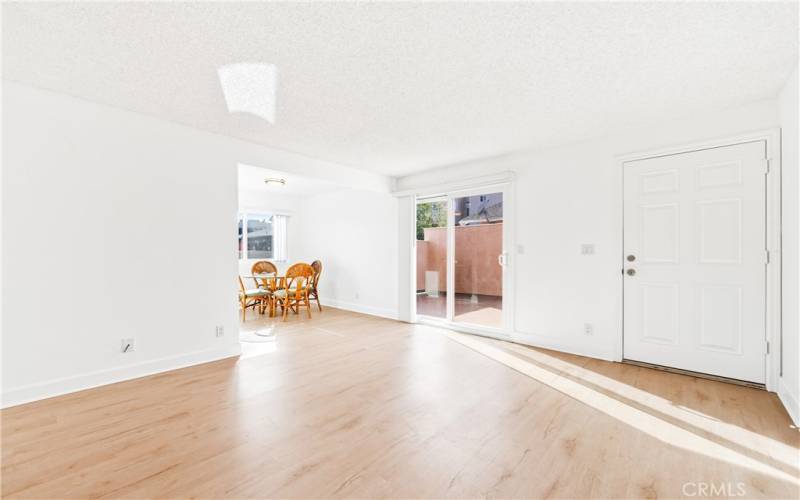 Spacious living room opens onto patio deck, eating area and kitchen