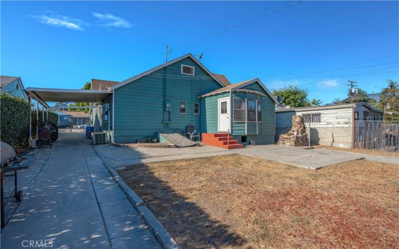 Rear view of home with basement access