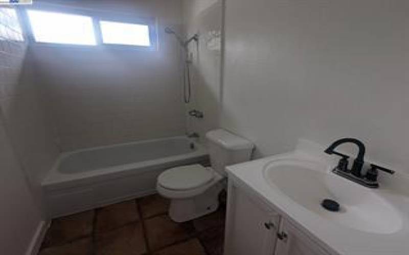 Upstairs bathroom with shower over tub