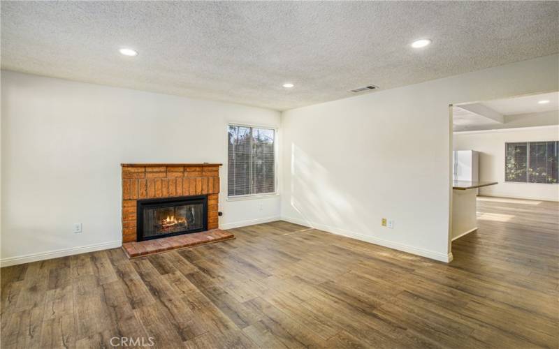 Front living room with wood burning fireplace.