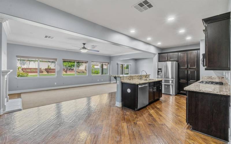 View from Dining Room toward the open concept floor plan downstairs with lots of windows to the back