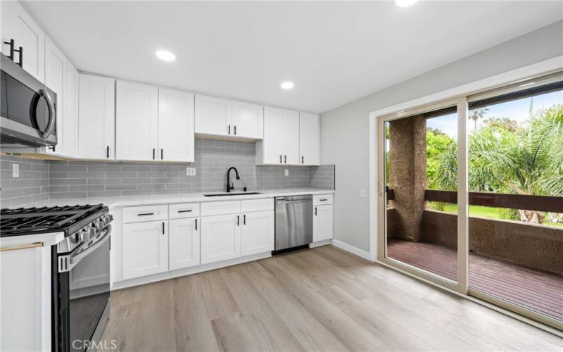 Enjoy the well-appointed kitchen, with plenty of white shaker style cabinets, quartz countertops!
