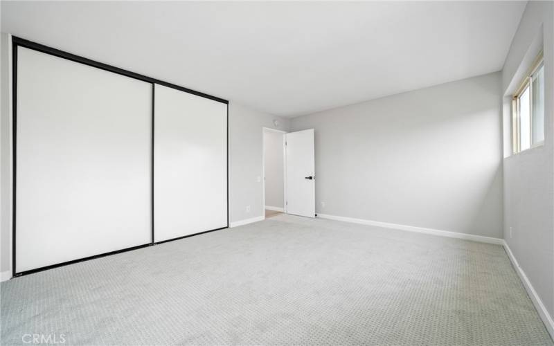 The primary bedroom has a nicely sized closet, new carpet flooring, and scraped ceiling!
