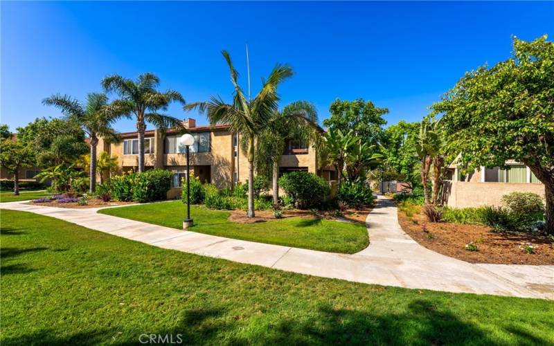 The home's exterior showcases a welcoming entrance with greenbelts!
