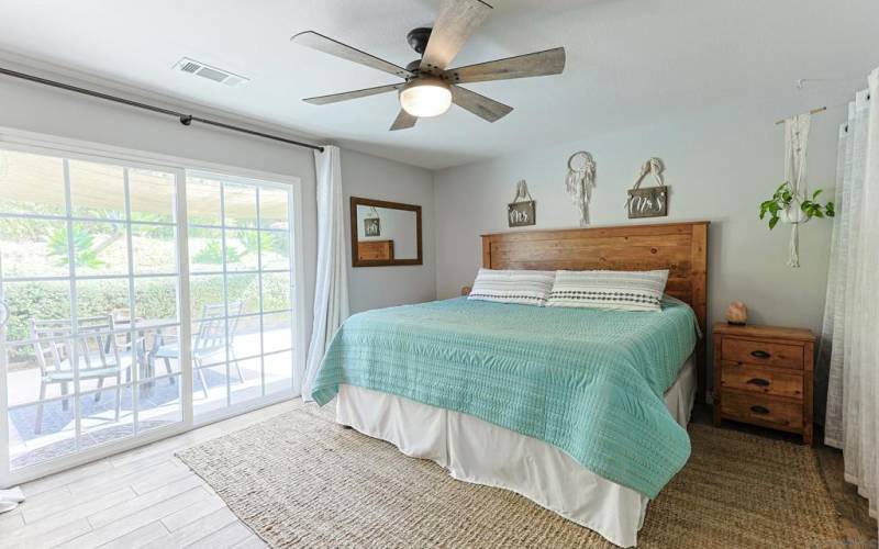 spacious primary bedroom with sliding door to the backyard.