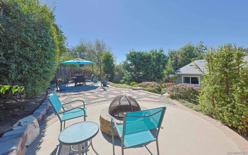 The tiered backyard space features an inviting outdoor firepit and dining area, perfect for entertaining guests. Plus, there's potential for an Additional Dwelling Unit (ADU) to suit your future needs.