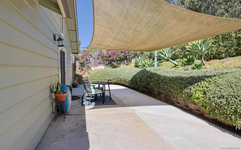 backyard lower area with a canopy shade