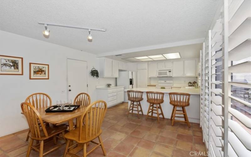 Kitchen eating area and room at the bar.